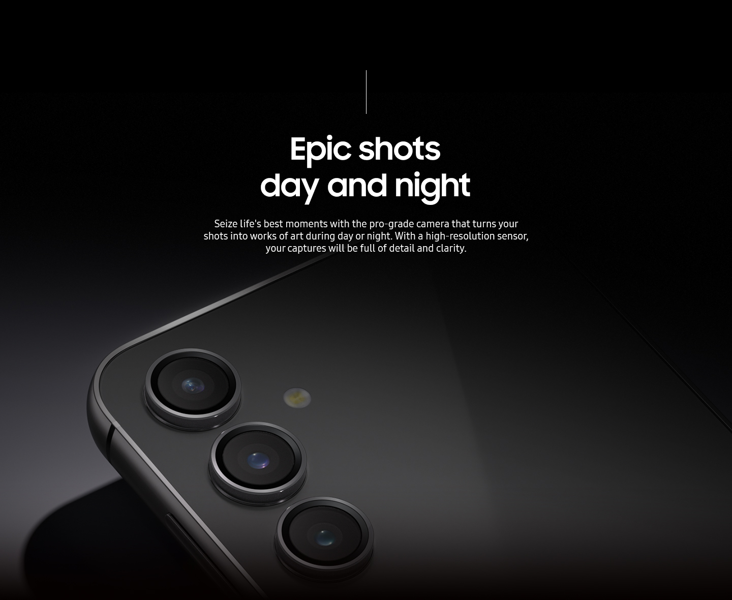 A Galaxy S23 FE device in Graphite lying on its front to show the rear camera in the dim light.