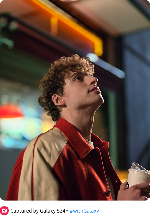 A vivid, detailed Nightography photo of a man at zoom.