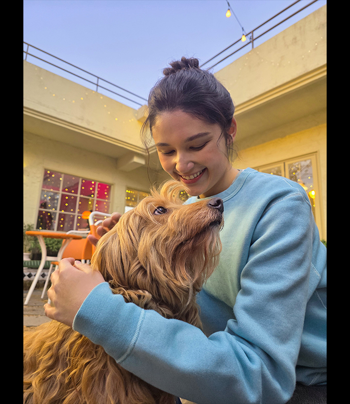 Portrait of a woman and a dog outdoors. Skin tones and textures are well captured.
