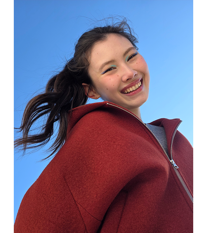 Portrait of a woman taken outdoors. Lighting is precise and subject's features are accurate.
